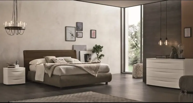 Camera da letto con letto imbottito e comò bianco